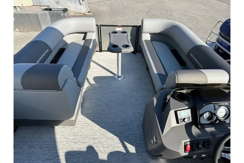 Slide: The Image of 2026 Bennington 23 SSR Quad Bench interior with gray seating and cup holders. - 11