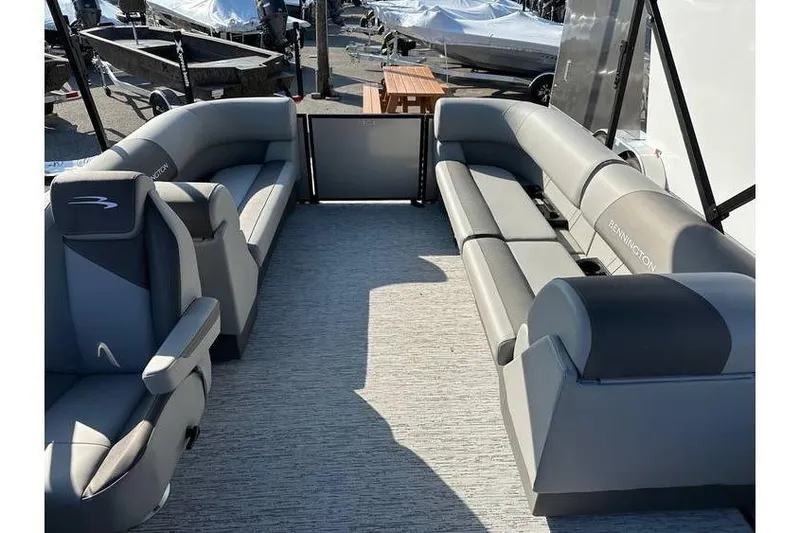 Slide: The Image of 2026 Bennington 23 SSR Quad Bench interior with gray seating and spacious layout. - 15