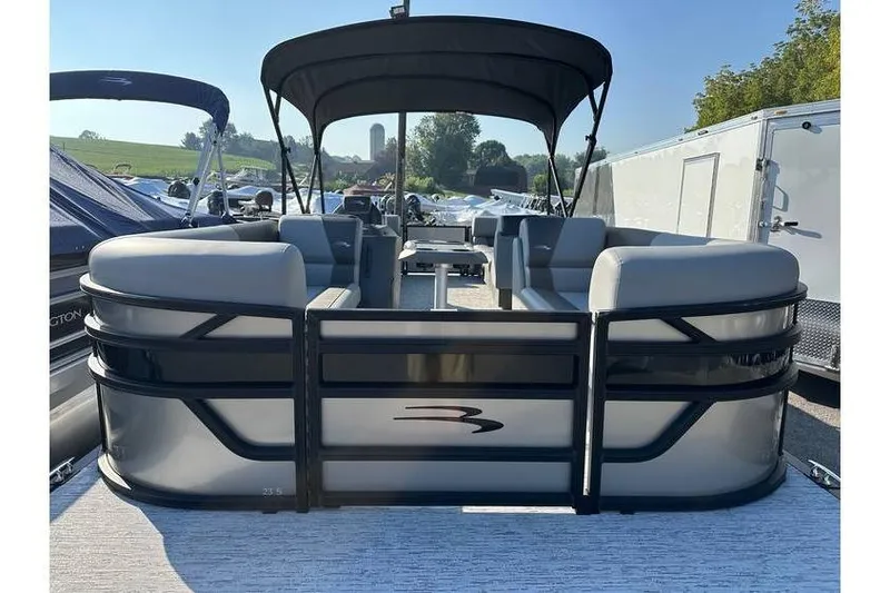 Slide: The Image of 2026 Bennington 23 SSR Quad Bench pontoon boat with canopy, docked outdoors. - 6