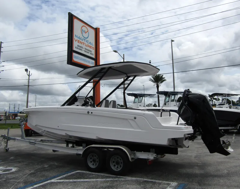 Slide: The Image of 2022 Axopar 22 T-Top boat on trailer at Nautical Ventures dealership. - 1
