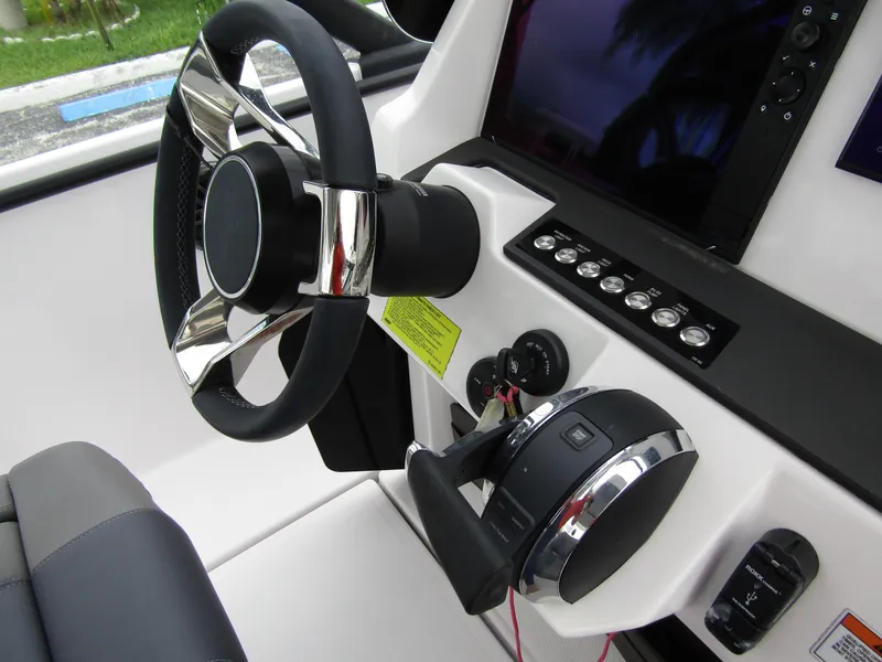 Slide: The Image of 2022 Axopar 22 T-Top boat steering wheel and control panel. - 17