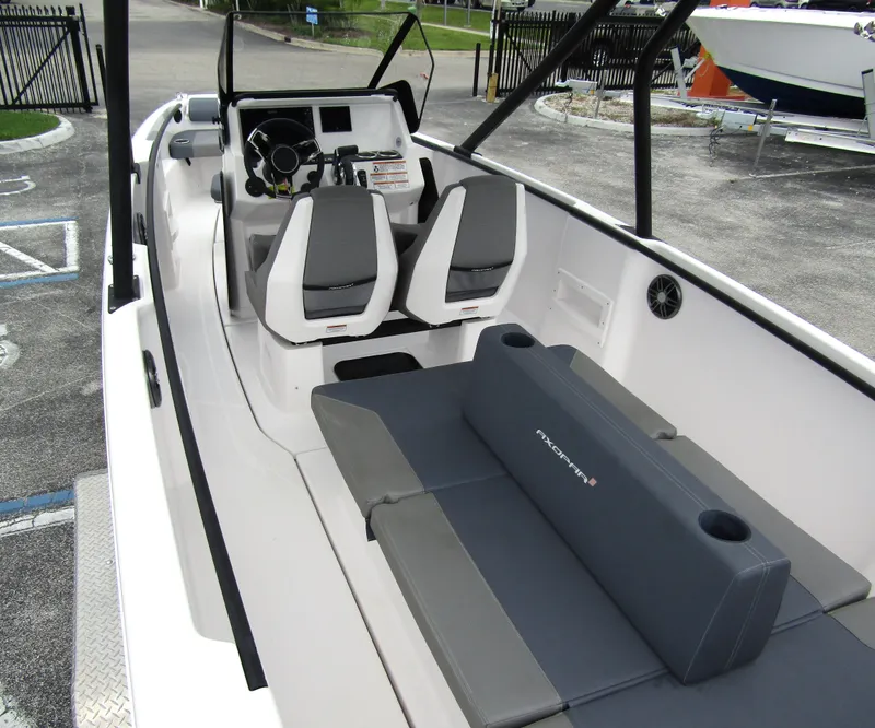 Slide: The Image of 2022 Axopar 22 T-Top boat interior with seating and steering console. - 19