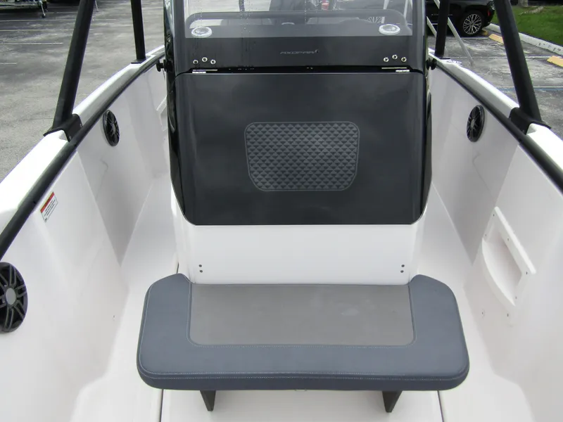 Slide: The Image of 2022 Axopar 22 T-Top boat interior with seating and dashboard. - 9