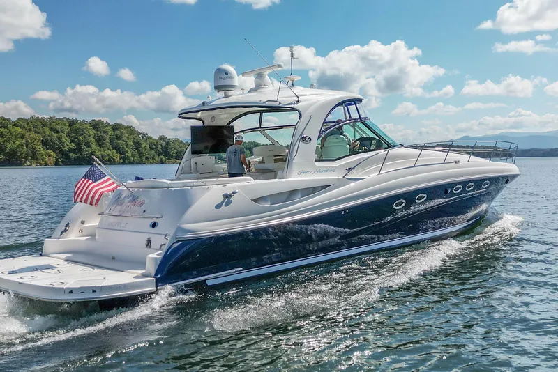 The Image of 2005 Sea Ray 500 Sundancer yacht cruising on a sunny day with American flag. - 0