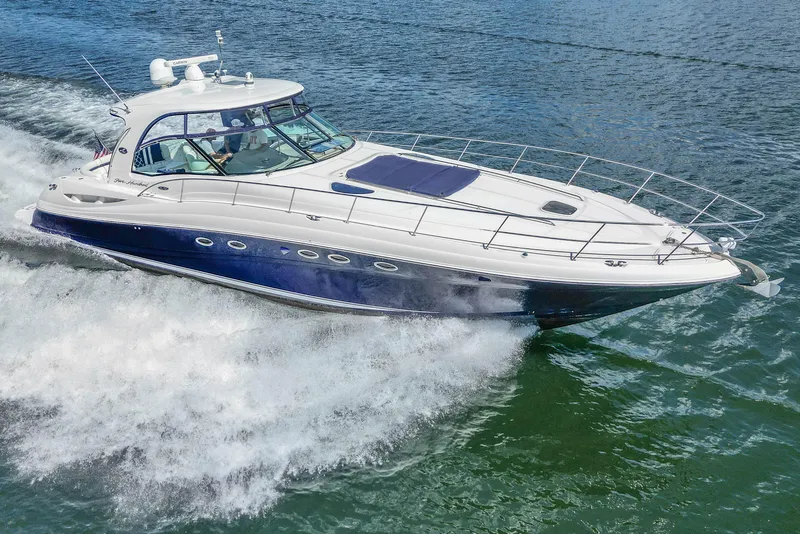 Slide: The Image of 2005 Sea Ray 500 Sundancer yacht cruising on open water, showcasing sleek design and performance. - 13