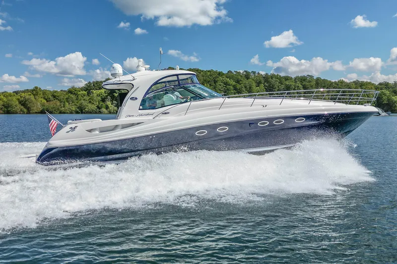 Slide: The Image of 2005 Sea Ray 500 Sundancer yacht cruising on a sunny day with lush greenery in the background. - 15