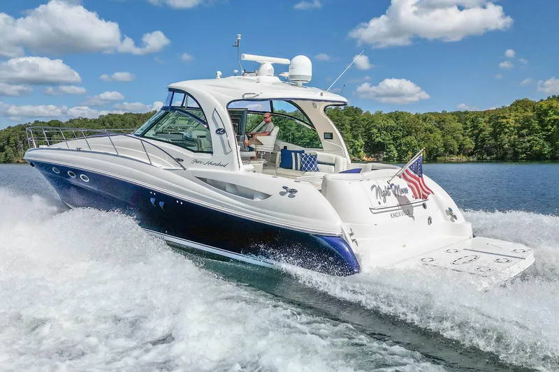Slide: The Image of 2005 Sea Ray 500 Sundancer cruising on a lake under a clear blue sky. - 20
