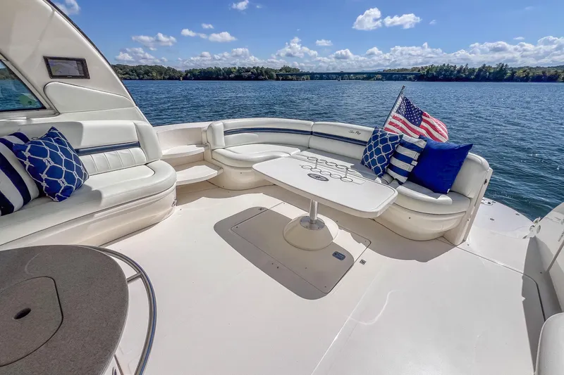 Slide: The Image of Luxurious 2005 Sea Ray 500 Sundancer yacht deck with seating, table, and American flag. - 26