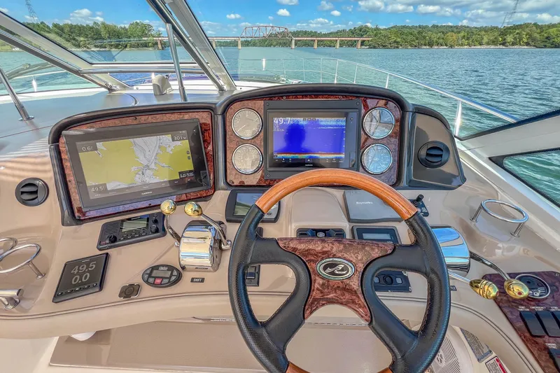 Slide: The Image of Helm of 2005 Sea Ray 500 Sundancer yacht with navigation screens and controls. - 29