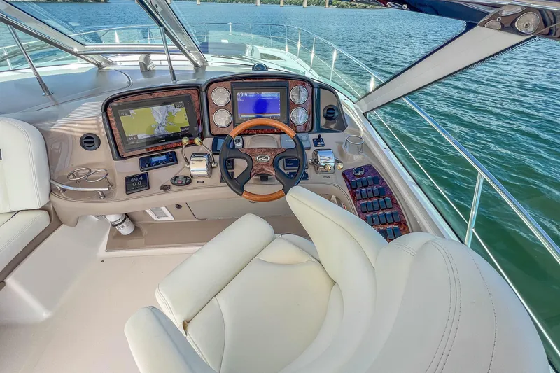 Slide: The Image of Cockpit of 2005 Sea Ray 500 Sundancer yacht with navigation displays and steering wheel. - 30