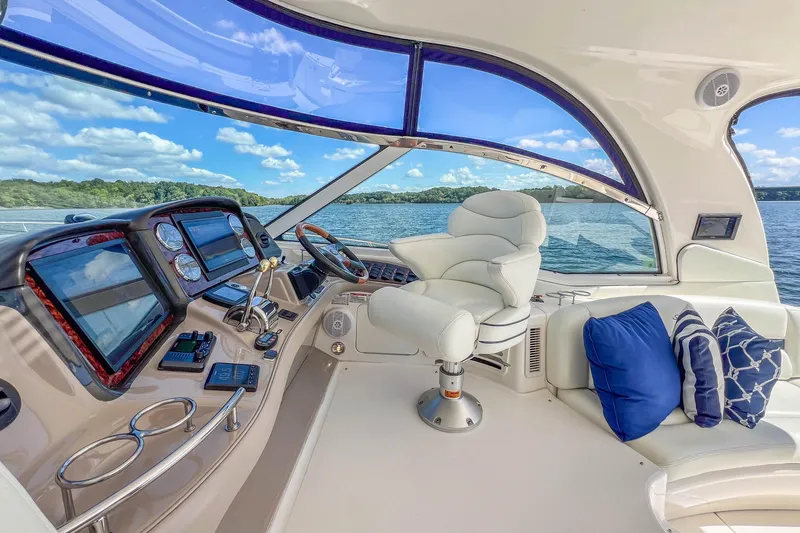 Slide: The Image of Luxurious 2005 Sea Ray 500 Sundancer yacht cockpit with plush seating and advanced navigation controls. - 32