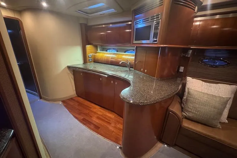 Slide: The Image of Luxurious 2005 Sea Ray 500 Sundancer yacht interior with modern kitchen and elegant wood finishes. - 42