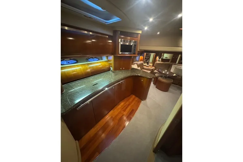 Slide: The Image of Luxurious interior of 2005 Sea Ray 500 Sundancer yacht with modern kitchen and seating area. - 44