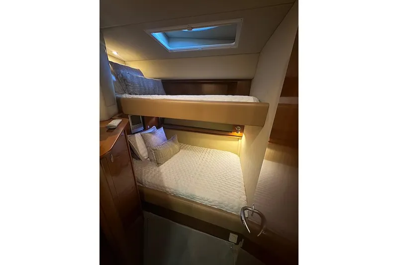 Slide: The Image of Interior of 2005 Sea Ray 500 Sundancer with cozy bunk beds and soft lighting. - 45