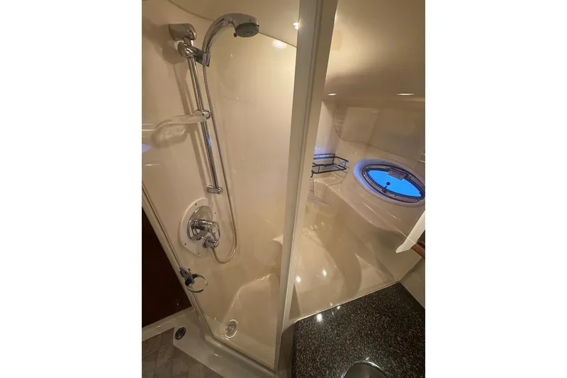 Slide: The Image of Luxurious bathroom in 2005 Sea Ray 500 Sundancer yacht with shower and porthole window. - 48