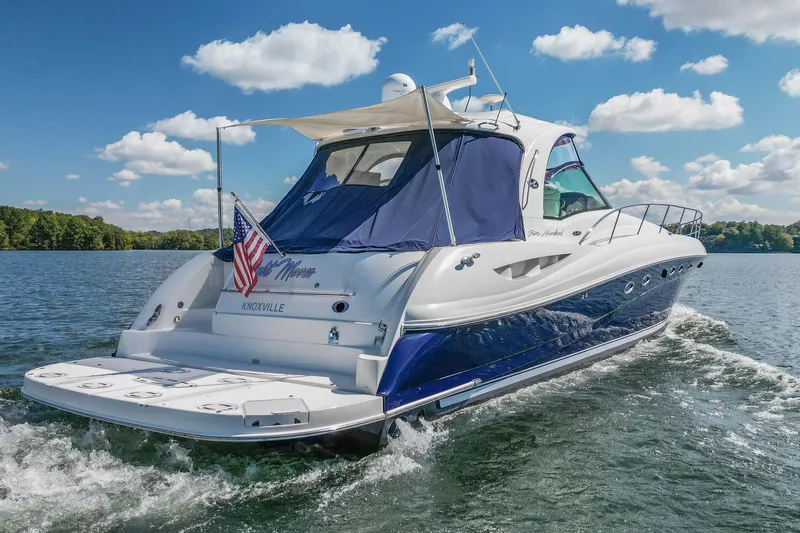 Slide: The Image of 2005 Sea Ray 500 Sundancer yacht cruising on a sunny day with American flag. - 5