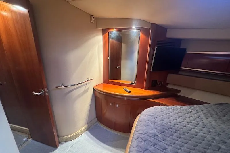 Slide: The Image of Luxurious cabin interior of 2005 Sea Ray 500 Sundancer yacht with wood finishes. - 52
