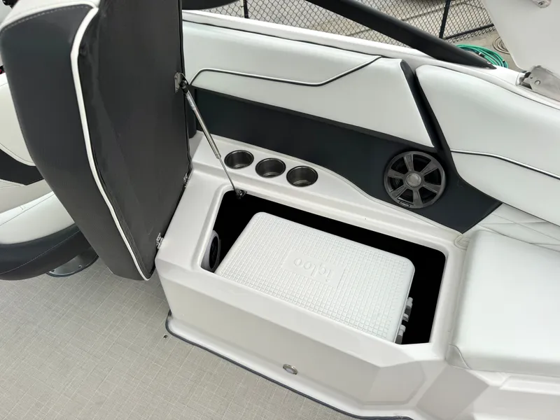Slide: The Image of The image shows an open storage compartment with an Igloo cooler in a Regal 23 OBX boat. - 7