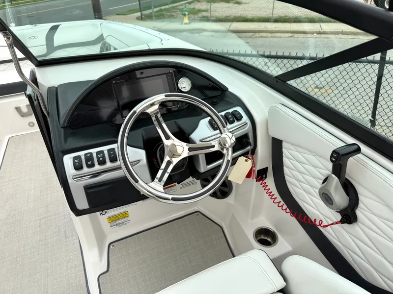 Slide: The Image of The cockpit of the 2022 Regal 23 OBX features a modern steering wheel and a sleek dashboard. - 14