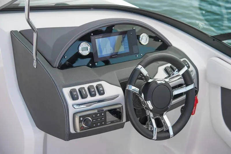 Slide: The Image of 2019 Regal 23 OBX boat dashboard with modern controls and steering wheel. - 43