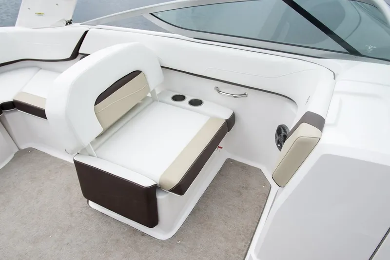 Slide: The Image of 2019 Regal 23 OBX boat interior seating with cup holders and white upholstery. - 46