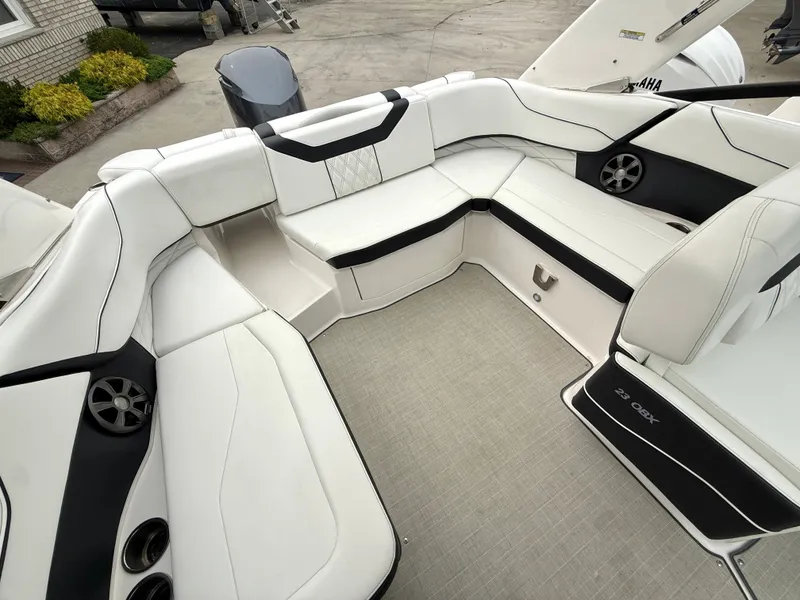 Slide: The Image of The image shows the cockpit of a 2022 Regal 23 OBX boat with white upholstery. - 5