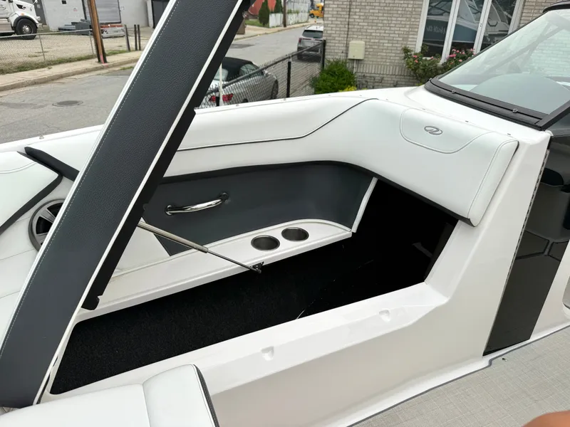 Slide: The Image of Interior view of a 2022 Regal 23 OBX boat with white and gray seating and cup holders. - 22