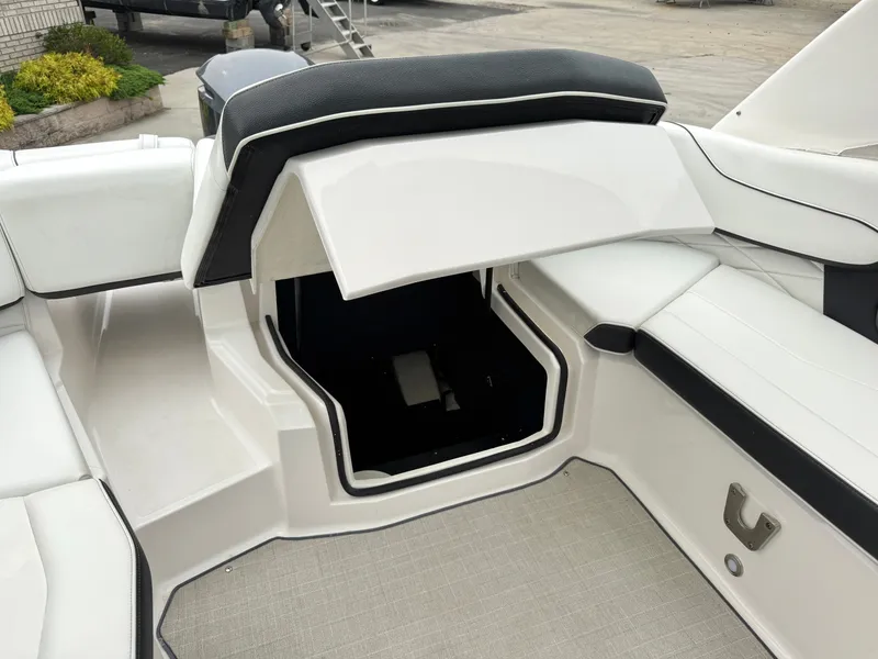 Slide: The Image of The image shows the interior of a 2022 Regal 23 OBX boat with storage under the seats. - 8