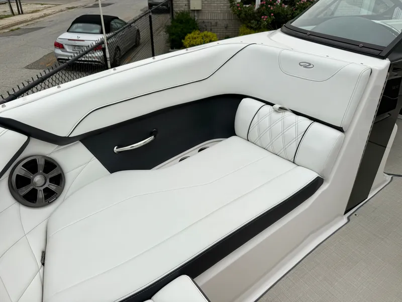 Slide: The Image of The image shows the luxurious white seating of a 2022 Regal 23 OBX boat. - 21