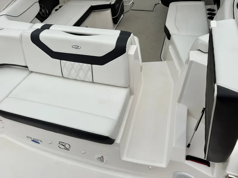 Slide: The Image of The image shows the cockpit of a 2022 Regal 23 OBX boat with white and black seating. - 3