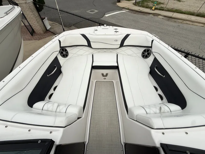 Slide: The Image of The image shows the cockpit of a 2022 Regal 23 OBX boat with white upholstery. - 17