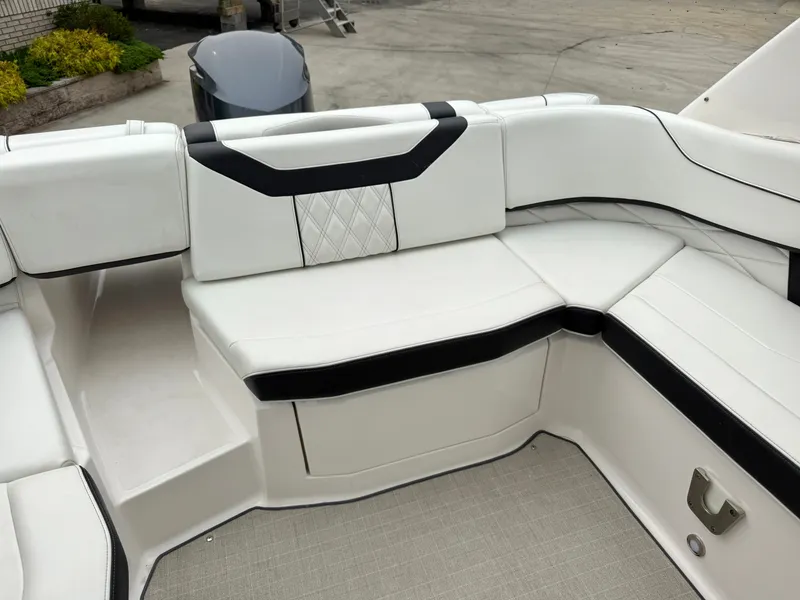 Slide: The Image of The image shows the white upholstery in the stern area of a 2022 Regal 23 OBX boat. - 9