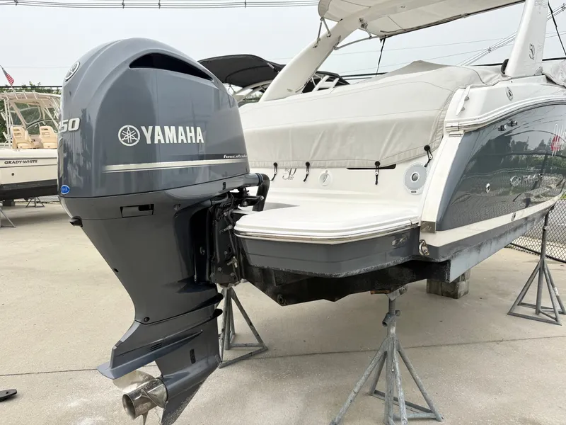 Slide: The Image of A 2022 Regal 23 OBX boat with a Yamaha outboard motor, stored on a stand. - 28
