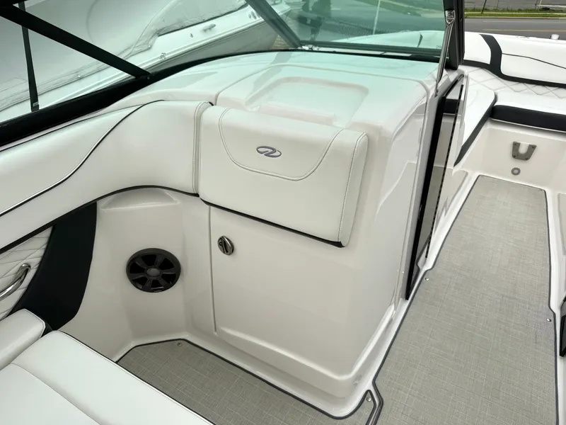 Slide: The Image of The image shows the cockpit of a 2022 Regal 23 OBX boat with white upholstery. - 25