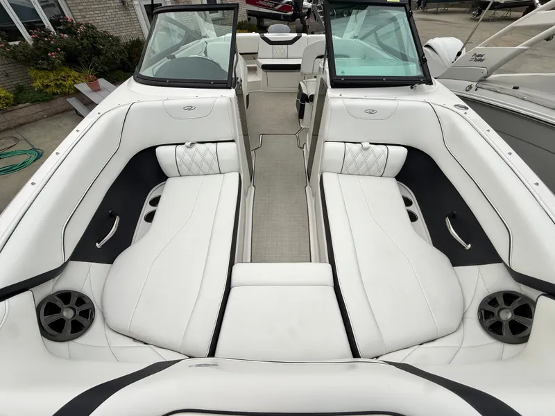 Slide: The Image of The image shows the cockpit of a 2022 Regal 23 OBX boat with white upholstery. - 20