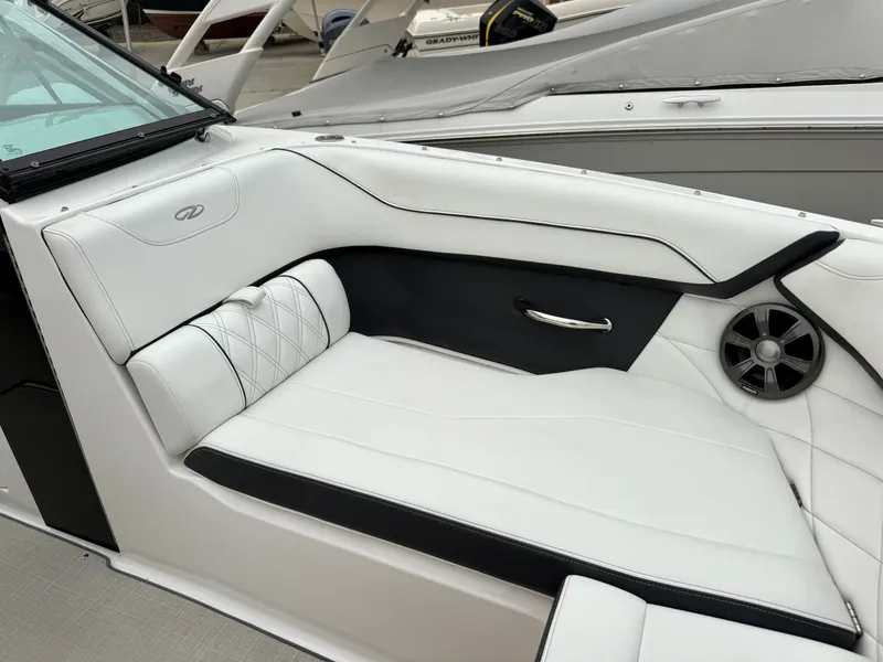 Slide: The Image of The image shows the luxurious white and black seating of a Regal 23 OBX boat. - 23