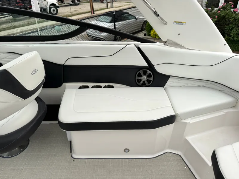 Slide: The Image of The image shows the interior of a 2022 Regal 23 OBX boat with white upholstery. - 6
