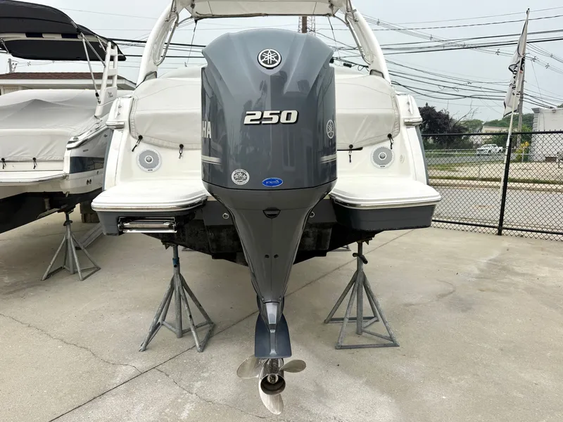 Slide: The Image of A 2022 Regal 23 OBX boat with a 250 HP outboard motor, stored on stands. - 27