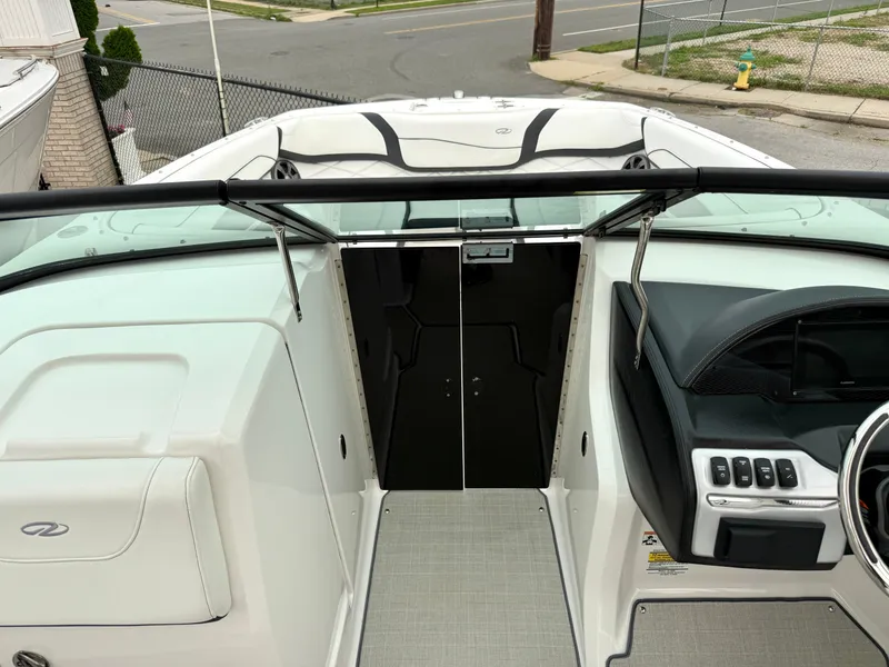 Slide: The Image of The image shows the cockpit of a 2022 Regal 23 OBX boat with modern controls. - 16
