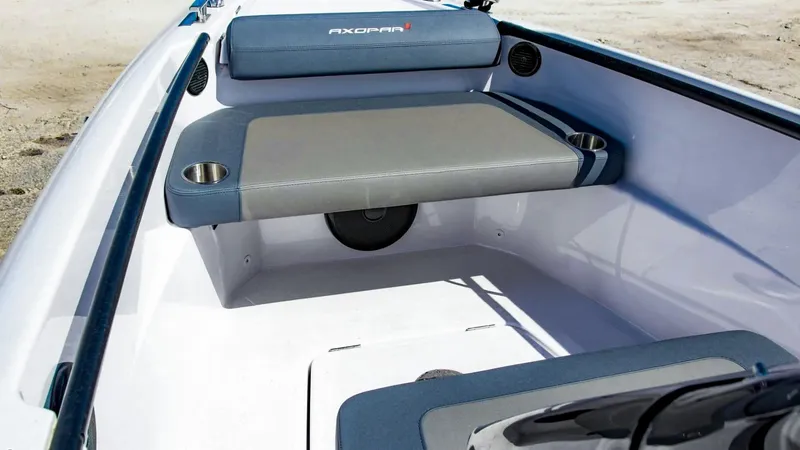 Slide: The Image of 2023 Axopar 22 T-Top boat interior with cushioned seating and cup holders. - 10