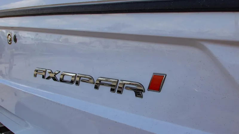 Slide: The Image of 2023 Axopar 22 T-Top boat logo on white hull - 12
