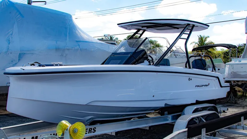 Slide: The Image of 2023 Axopar 22 T-Top boat on a trailer, side view. - 3