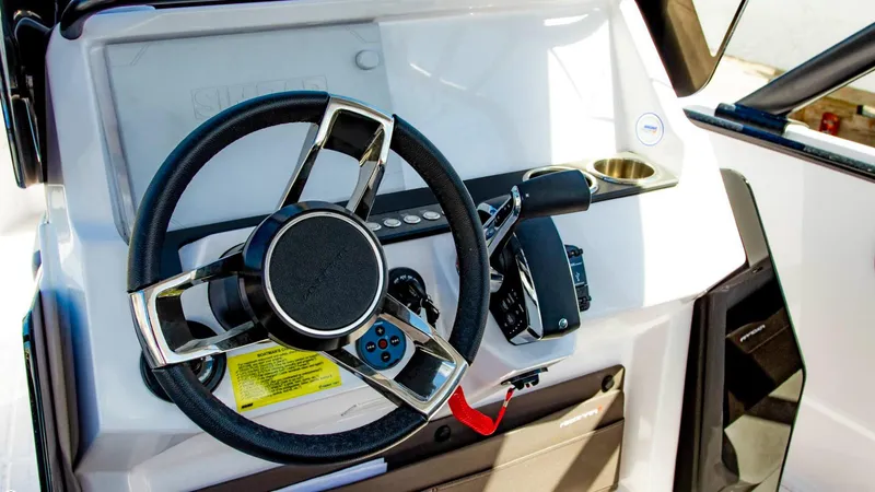 Slide: The Image of 2023 Axopar 22 T-Top steering console with modern controls and sleek design. - 4