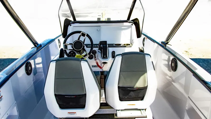 Slide: The Image of 2023 Axopar 22 T-Top boat interior with dual seats and steering console. - 6