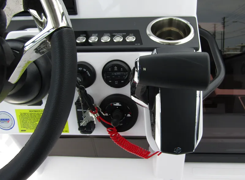 Slide: The Image of Close-up of the 2024 Axopar 25 Cross Top boat's control panel and steering wheel. - 17