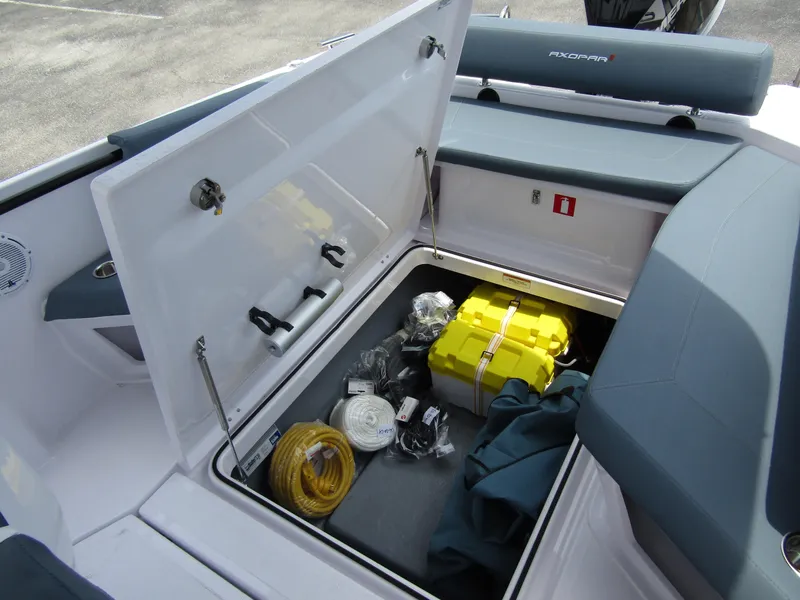 Slide: The Image of Storage compartment of 2024 Axopar 25 Cross Top boat with safety equipment and accessories. - 27