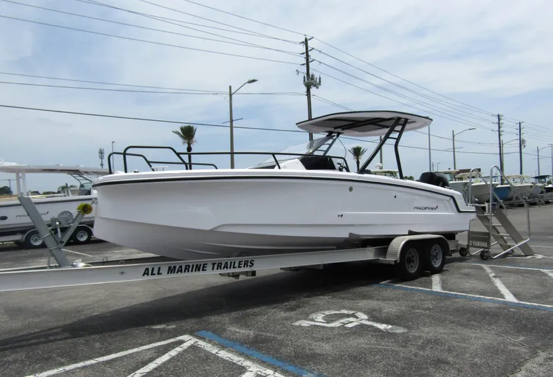 Slide: The Image of 2024 Axopar 25 Cross Top boat on a trailer in a parking lot. - 7