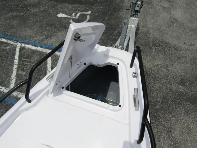 Slide: The Image of 2024 Axopar 25 Cross Top boat with open storage compartment. - 9