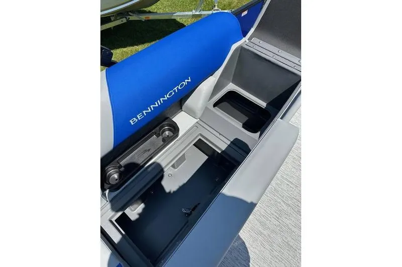 Slide: The Image of 2026 Bennington 23 SSB Swing Back Pontoon interior storage compartment with blue seating. - 17