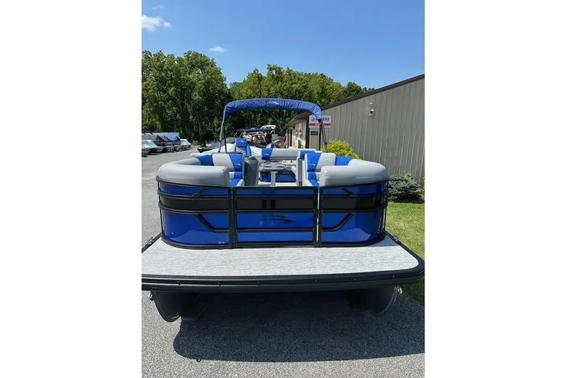 Slide: The Image of 2026 Bennington 23 SSB Swing Back Pontoon, blue and gray, parked outdoors. - 3